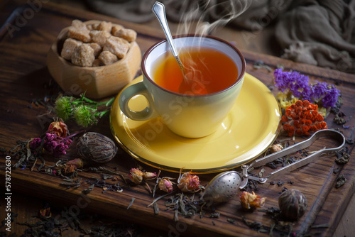 Sweet  hot tea with dry tea leaves  on an old background.