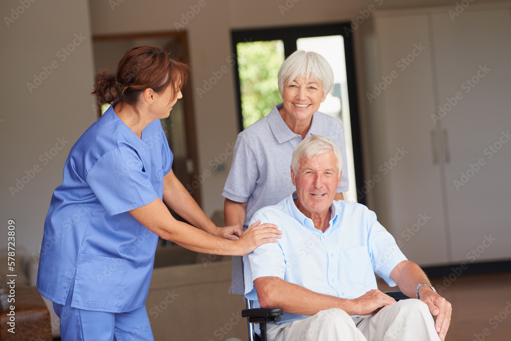 Feeling well looked after and supported. a nurse standing by her senior patient and his wife. Feeling well looked after and supported. a nurse standing by her senior patient and his wife.