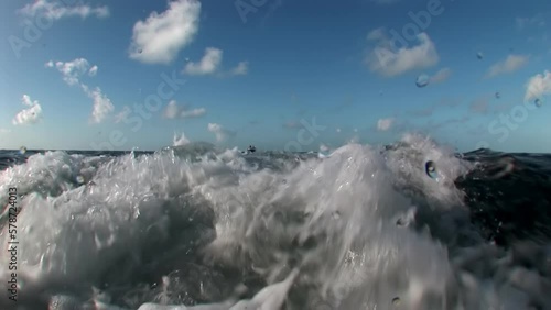 Caribbean sea seething water close-up background horizon of blue sky. Pollution, overfishing, and climate change all threaten health of coral reefs and creatures that call them home. photo