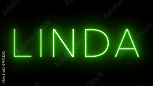 Flickering green retro style neon sign glowing against a black background