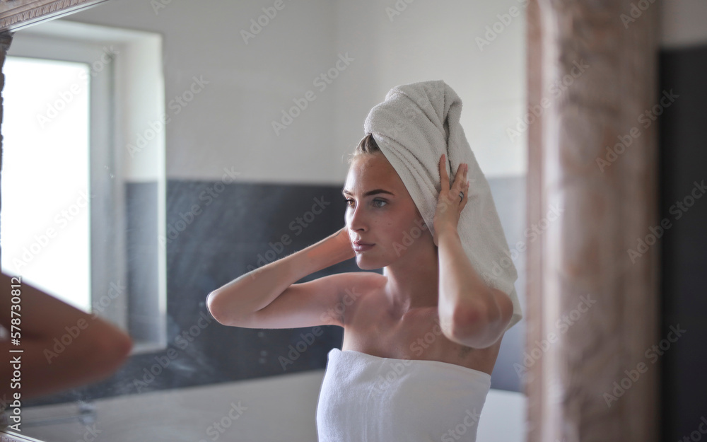 young woman in front of the mirror in the bathroom young woman in front of the mirror in the bathroom
