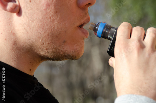 Boy smoking electronic cigarette. Harmful and technology concept