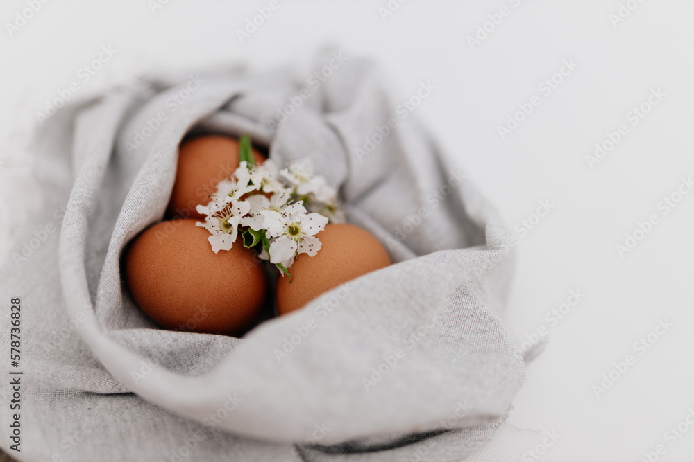 Easter still life on white background, painted red eggs in linen napkin. Mock up for spring card Easter still life on white background, painted red eggs in linen napkin. Mock up for spring card