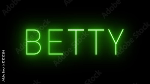 Flickering green retro style neon sign glowing against a black background
