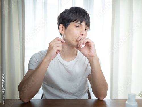 髭の毛抜きをする男性