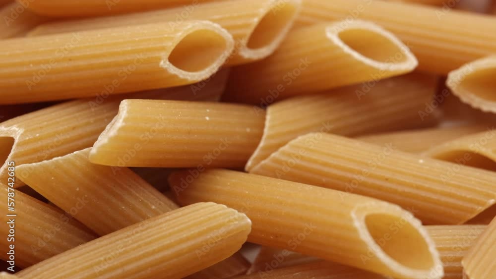Raw Italian Pasta. Penne Rigate. Panning Dolly Slider Shot. Top View. Macro. 4k, 60 FPS, ProRes. Raw Italian Pasta. Penne Rigate. Panning Dolly Slider Shot. Top View. Macro. 4k, 60 FPS, ProRes.