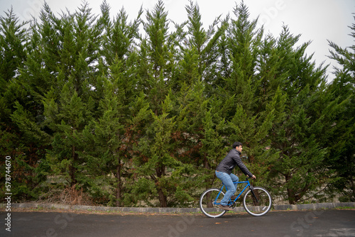 Man riding a bike in tree background