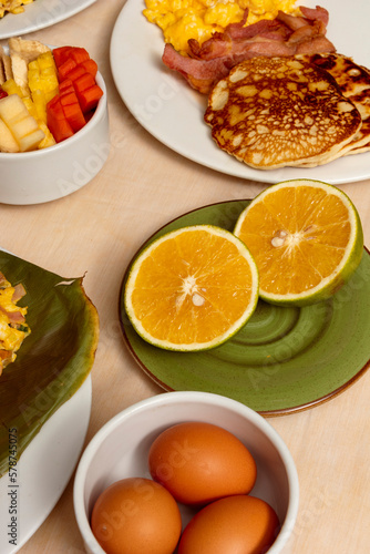 halved oranges on table of many colombian breakfast dishes