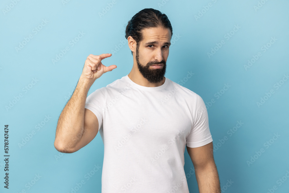 Man discusses something very small, shapes something very tiny, purses lips, asks tiny object. Man discusses something very small, shapes something very tiny, purses lips, asks tiny object.