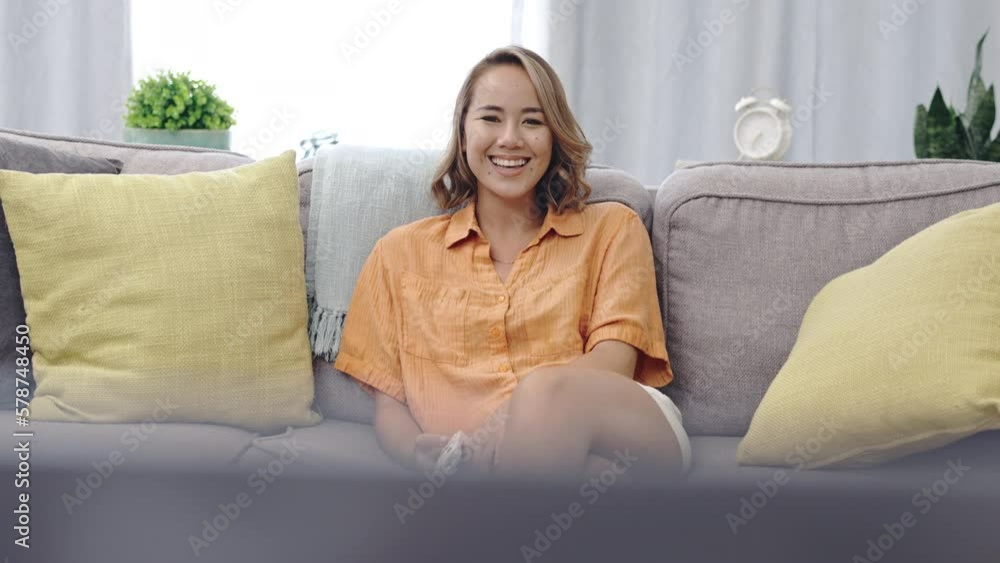 Happy woman on couch watching tv for funny show, film or comedy movie at home in her living room or apartment. Television, relax and face of asian female with remote on sofa on live streaming service Happy woman on couch watching tv for funny show, film or comedy movie at home in her living room or apartment. Television, relax and face of asian female with remote on sofa on live streaming service