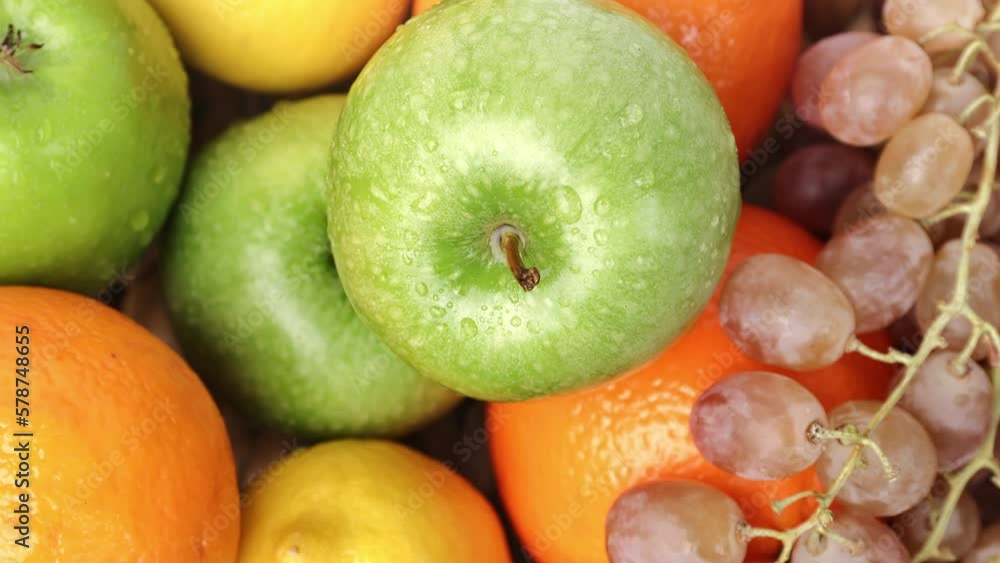 Fresh fruit green apple orange lemon grape heap vegetarian summer organic vitamin rotation top view Fresh fruit green apple orange lemon grape heap vegetarian summer organic vitamin rotation top view