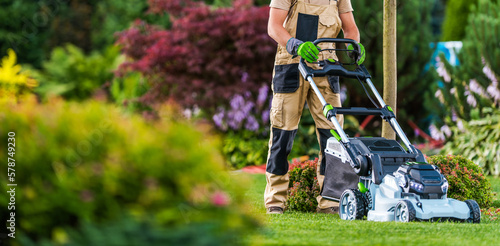 Fotografie Summer Time Lawn Mowing in Colourful Blooming Garden