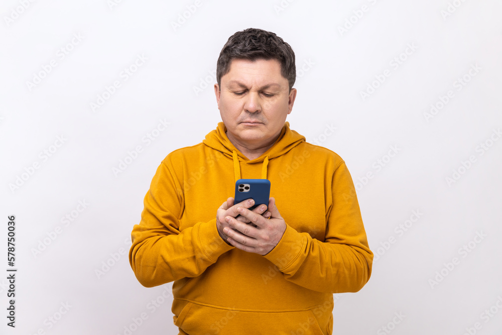 Middle aged man texting message in social media on cell phone, using mobile network services. Middle aged man texting message in social media on cell phone, using mobile network services.