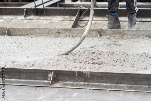 Construction technician uses concrete vibration generator during leveling concrete. Construction worker using concrete vibrator removal air bubbles for maximum strength in concrete