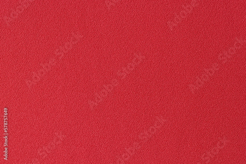 Plain unicolorous red textile as background.