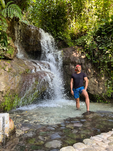 Man standing in-front of amazing waterfalls in nature. 