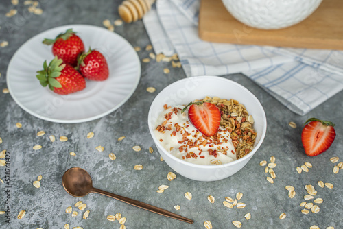 Healthy food concept: homemade granola with yogurt and strawberries. Oatmeal with freeze-dried strawberries, fresh berries and honey. Delicious and healthy breakfasts