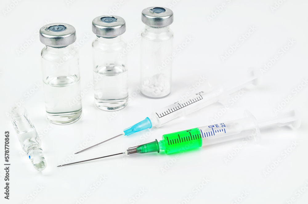 Green vaccine and two syringe on white background Green vaccine and two syringe on white background