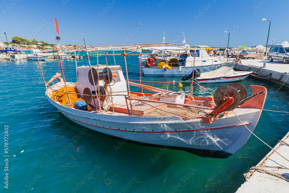 Small wooden fishing boat moored in port of Agios Sostis village