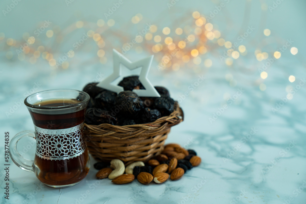 Black tea dates and dry fruits with a star on it , Ramadan and Eid concept 2023