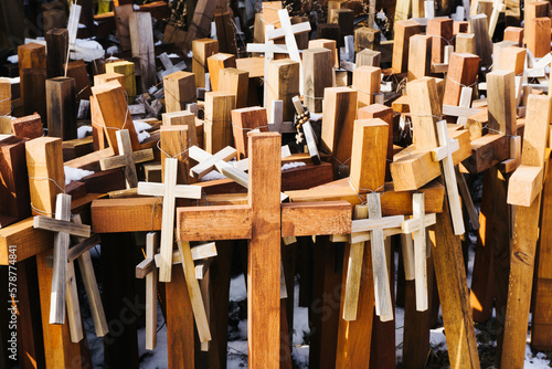 Wooden cross symbol of christianity texture. Holy place catholic religion. Hanging rosary background. Pilgrimage destination. Cementary landscape. Graveyard symbol. Hope background. photo