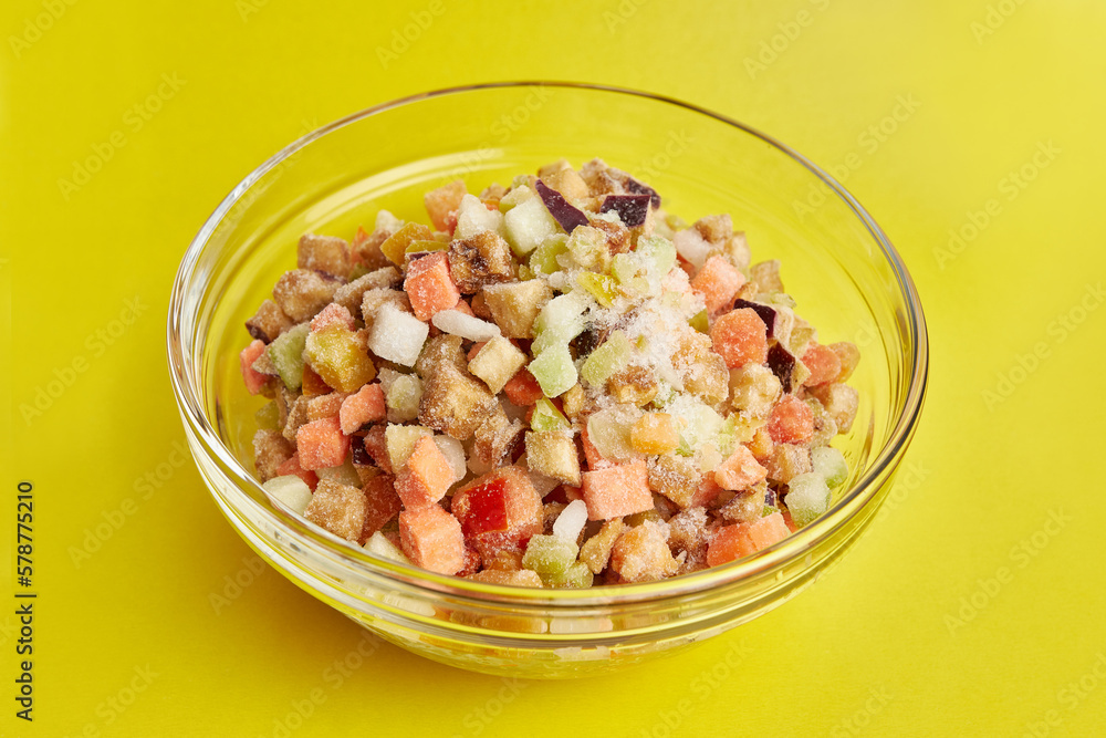 A bowl of chopped frozen vegetables. Cooking dishes from vegetables. Eggplants, tomatoes, zucchini, peppers, onions. A bowl of chopped frozen vegetables. Cooking dishes from vegetables. Eggplants, tomatoes, zucchini, peppers, onions.