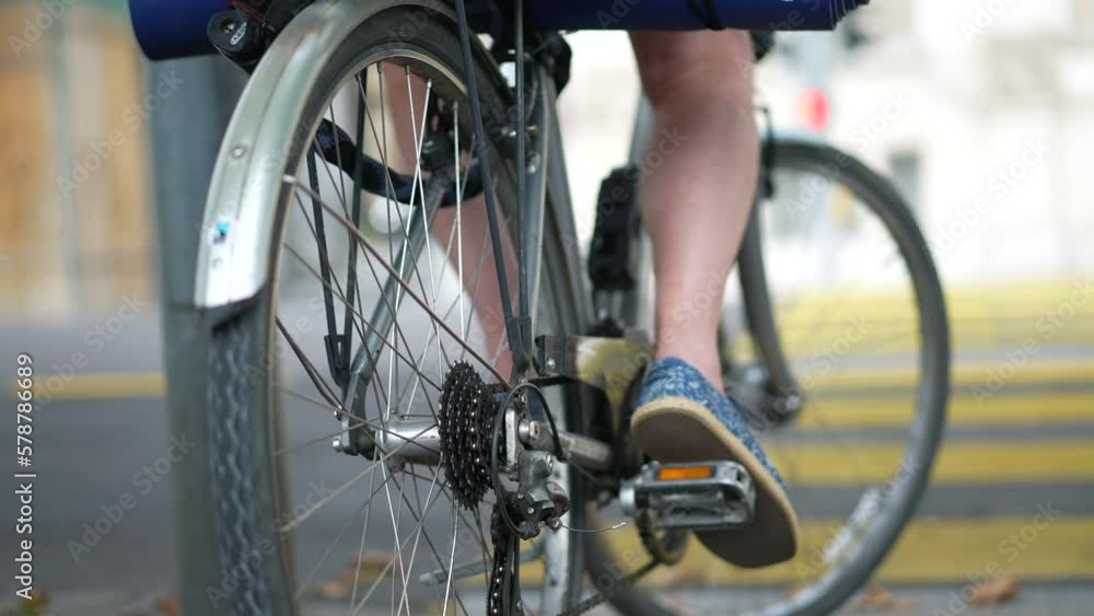 Closeup person legs sitting on bicycle on standby waiting to cross street Closeup person legs sitting on bicycle on standby waiting to cross street