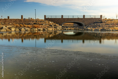 Beautiful early spring landscape with a pond and reflections in the small neighborhood park in Aurora, Colorado