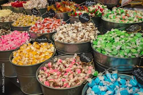 Buckets filled with taffy candy at a candy shop. A variety of candy in a store