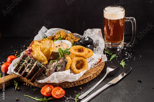 Big dish of different products for beer on wooden background