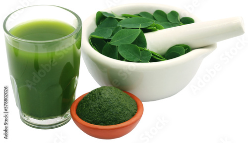 Mashed moringa leaves with extract in a glass photo