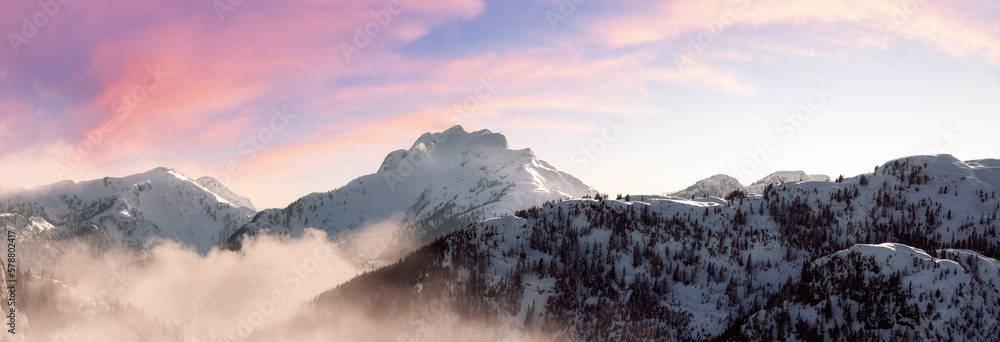Aerial View from Airplane of Snow Covered Canadian Mountain Landscape in Winter. Colorful Pink Sky Art Render. Near Squamish, North of Vancouver, British Columbia, Canada.