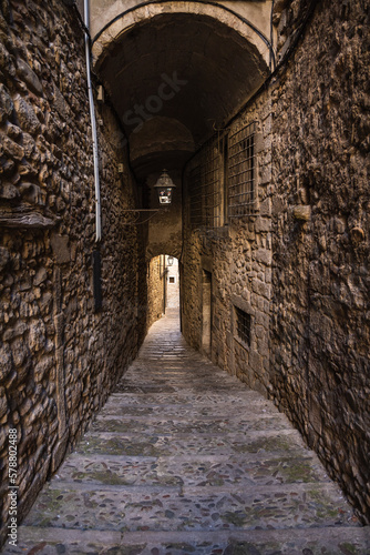 Medieval narrow stone street with tunnel in Girona  Spain