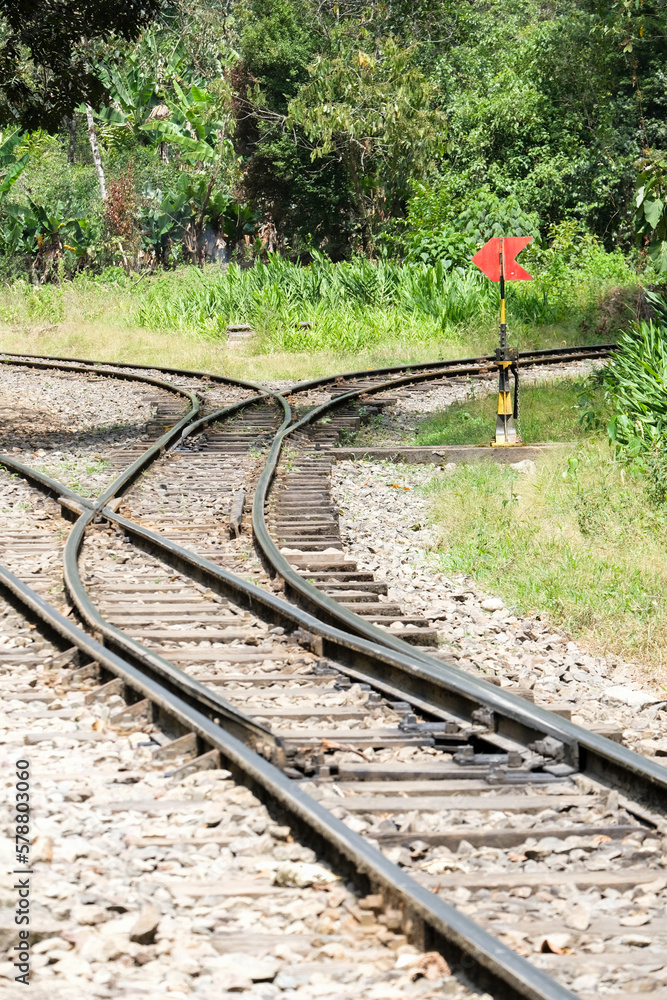 Obraz premium Empty railway switch crossing point inside forest. Selective focus.