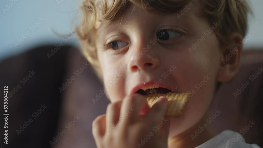 Happy child snacking cookie dessert. One small boy closeup face eating sugar carb food Happy child snacking cookie dessert. One small boy closeup face eating sugar carb food