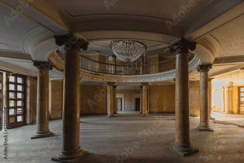 Entrance round hall with chandelier at the abandoned palace