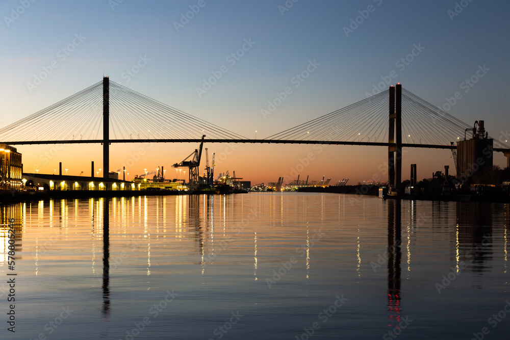 The 1991 cable-stayed Talmadge Memorial Bridge over the Savannah River seen illuminated at night, with the reflection of its lights in the water, Savannah, Georgia, USA
