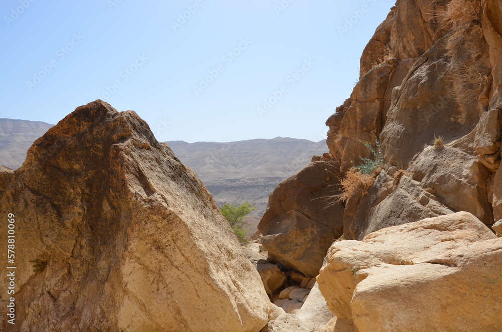 Panoramic view of the rocks, canyons and the desert and dry landscape surrounding Madaba, Jordan, on a bright sunny day.