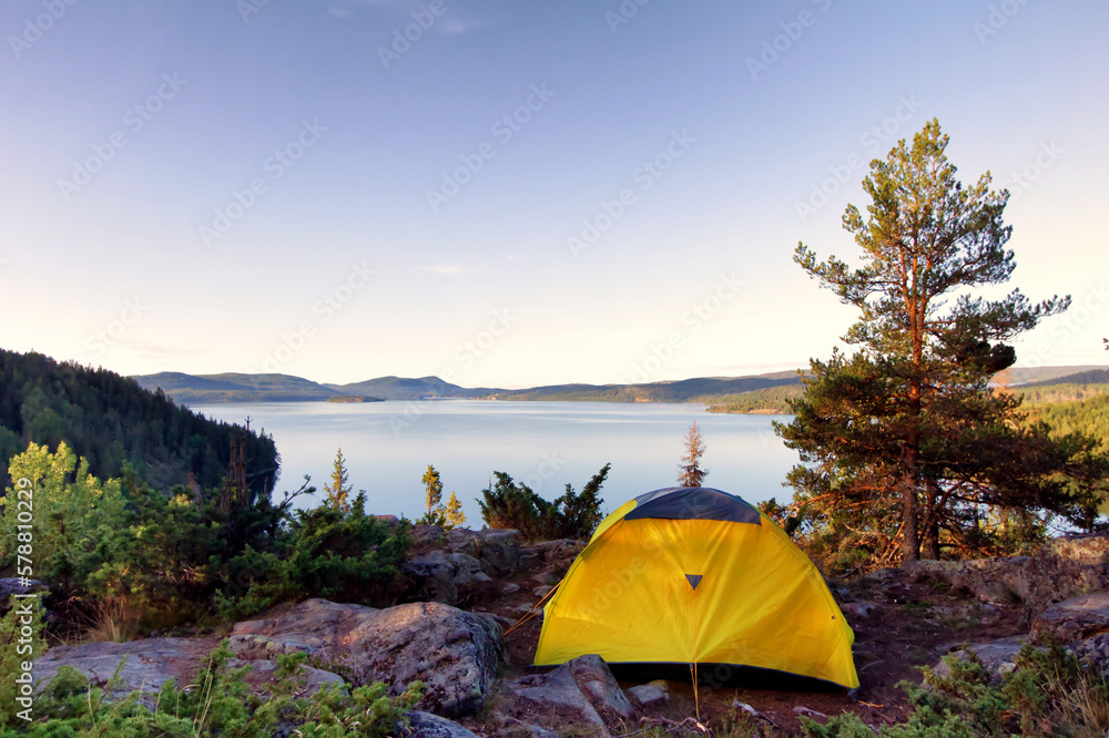 Tent in the Swedish wilderness with scenic view over lake, mountains and forest