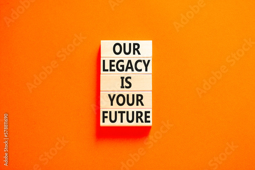 Legacy and future symbol. Concept words Our legacy is your future on wooden blocks. Beautiful orange table orange background. Business legacy and future concept. Copy space.