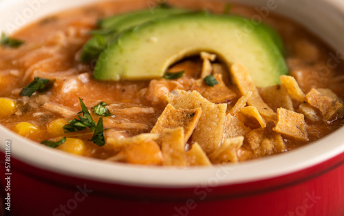 chicken noodle soup with tortilla and avocado