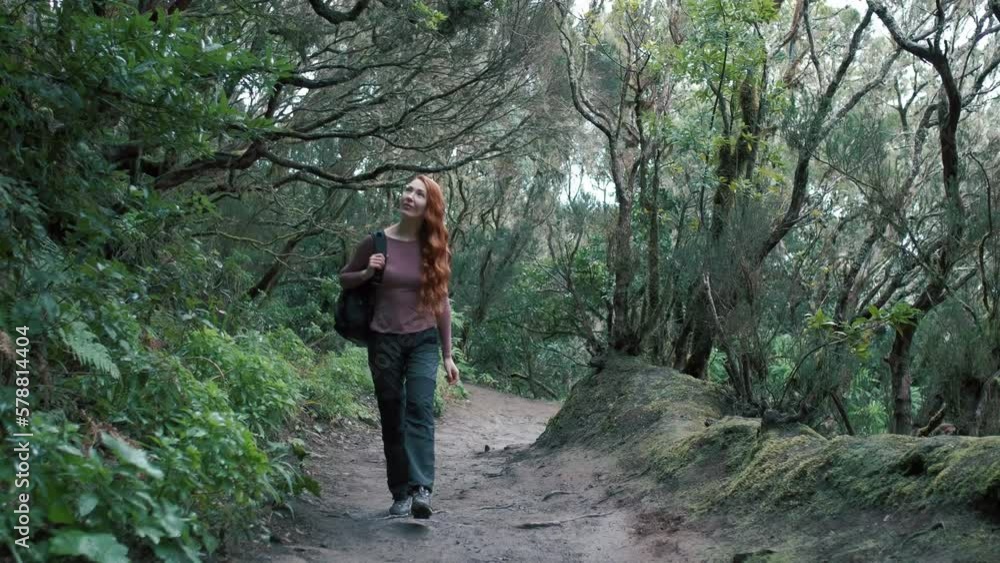 Woman is walking in an enchanted forest. Redhead girl with a long hair. Woman is walking in an enchanted forest. Redhead girl with a long hair.