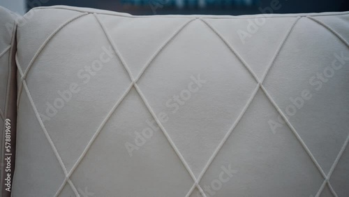 Close-up to the quality of the white sofa with rhombus-shaped lines. 4k video.