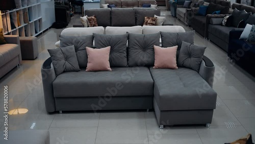 Slow motion frame to a comfortable gray sofa with gray and beige pillows. Home decor concept. 4k video.