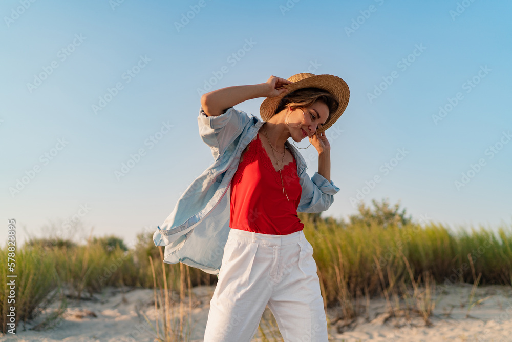 stylish attractive woman on beach in summer style fashion trend outfit happy having fun