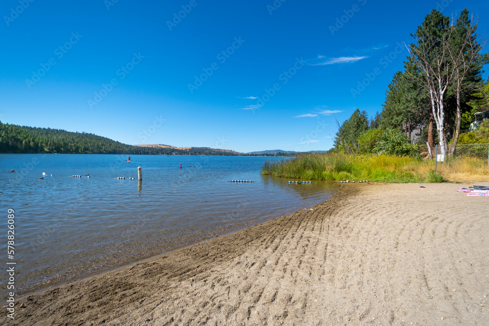 The sandy shoreline at the public Liberty Lake State Park on a summer day in Liberty Lake, a suburb of Spokane, Washington, USA.