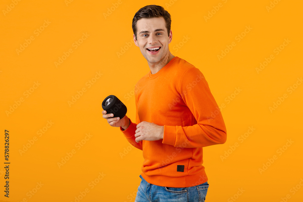 stylish young man holding wireless speaker stylish young man holding wireless speaker