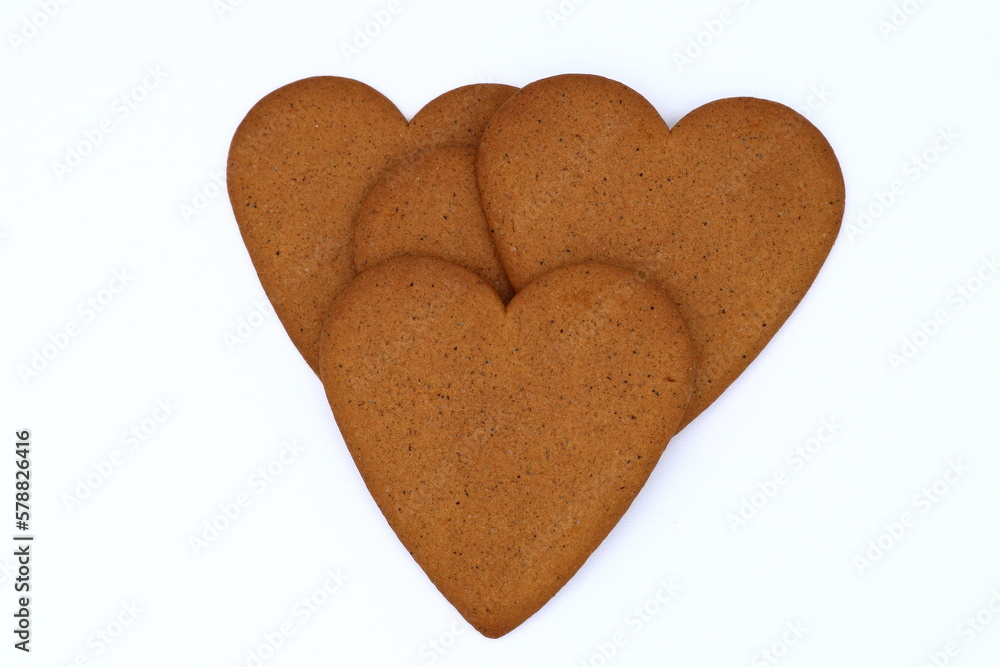 A bunch of gingerbread cookies shaped as one heart. Layers of cake. Isolated on white background. A bunch of gingerbread cookies shaped as one heart. Layers of cake. Isolated on white background.