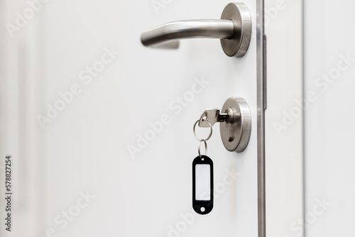 White door, door handle, door lock with key. Copyspace, place for text. © speed300