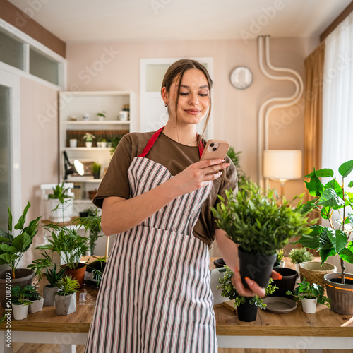 One young woman take care of plant and photos with her smartphone